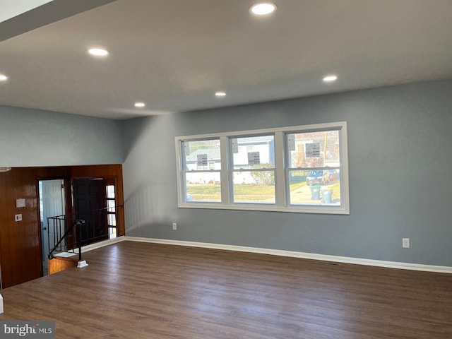 spare room with dark wood-type flooring