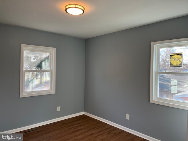 empty room with dark hardwood / wood-style floors