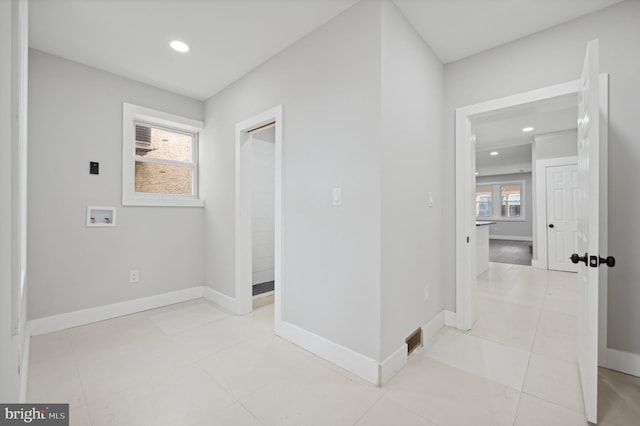 hall with light tile patterned flooring