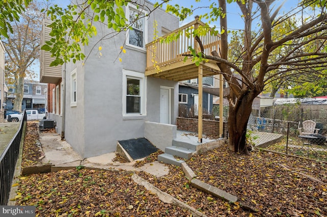 view of front of home featuring central AC unit and a wooden deck