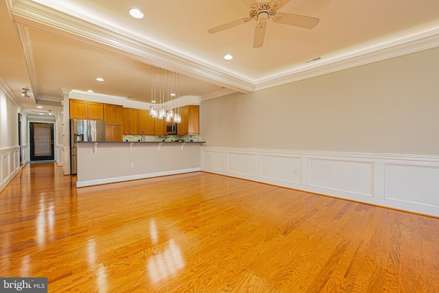 unfurnished living room with ceiling fan, light hardwood / wood-style floors, and crown molding