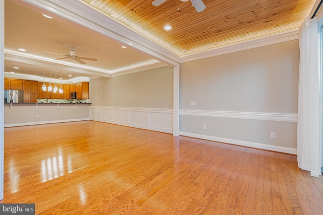 spare room with wood ceiling, ceiling fan, light hardwood / wood-style floors, and ornamental molding