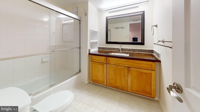 full bathroom featuring vanity, toilet, and combined bath / shower with glass door