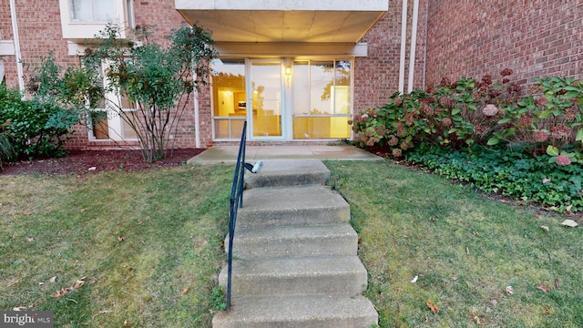 doorway to property with a yard