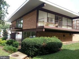 rear view of property featuring a lawn