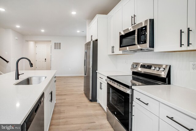 35551 Aspen Way, Locust Grove, VA 22508 - kitchen featuring stainless steel appliances, sink, white cabinets, and light hardwood / wood-style floors