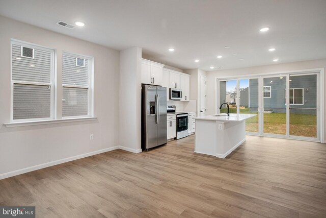 35551 Aspen Way, Locust Grove, VA 22508 - kitchen with sink, a center island with sink, stainless steel appliances, light hardwood / wood-style floors, and white cabinets