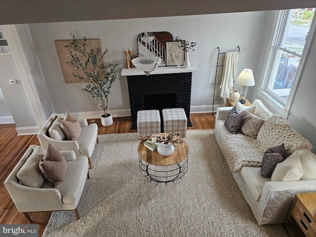 living room with hardwood / wood-style floors and a fireplace