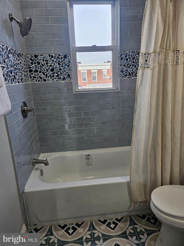 bathroom with tile patterned flooring, shower / bath combination with curtain, and toilet