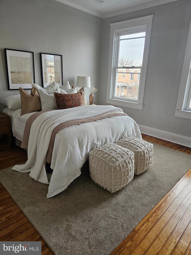 bedroom featuring dark hardwood / wood-style floors and ornamental molding