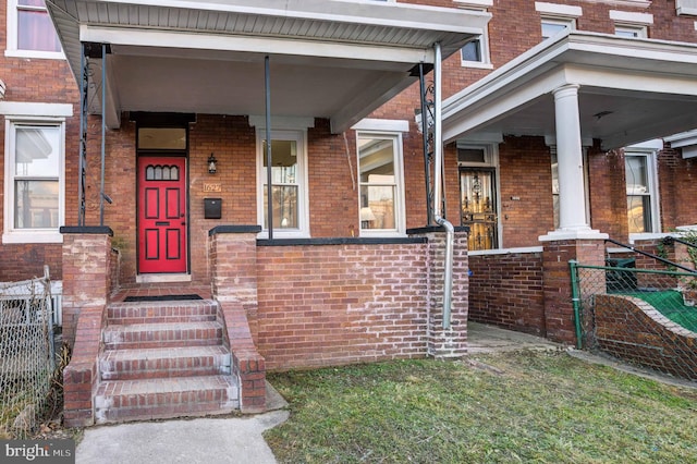 view of exterior entry with a porch