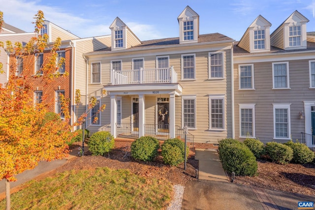 view of front facade featuring covered porch and a balcony