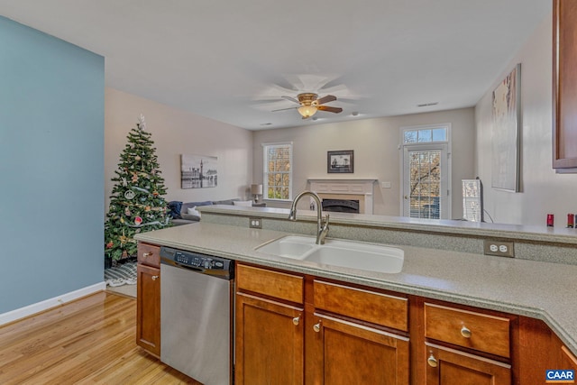 kitchen with dishwasher, light hardwood / wood-style floors, sink, and a wealth of natural light