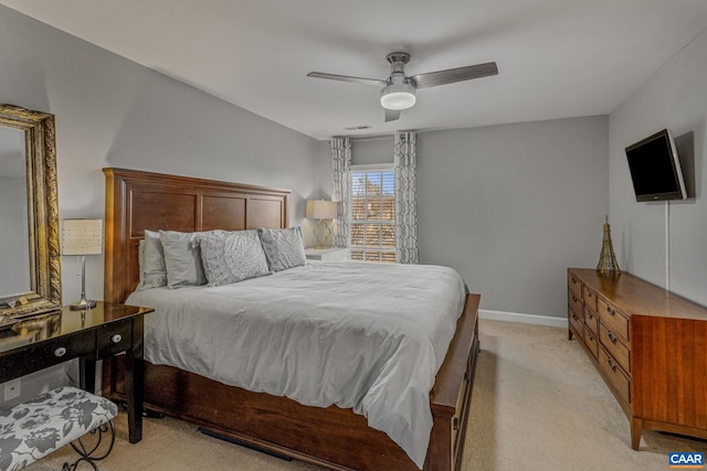 bedroom with ceiling fan and light carpet