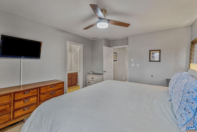 carpeted bedroom featuring ensuite bathroom and ceiling fan