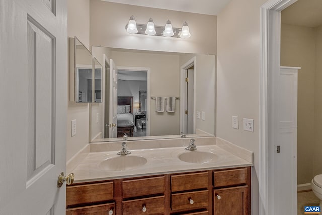 bathroom featuring vanity and toilet