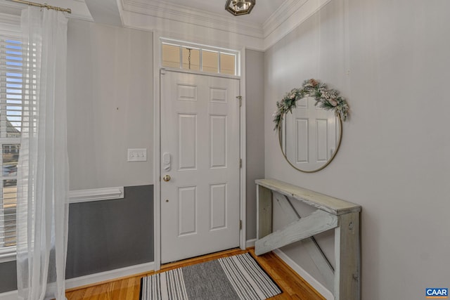 foyer featuring crown molding and wood-type flooring