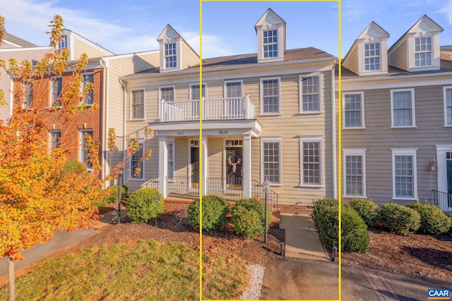 view of front facade with a balcony and covered porch