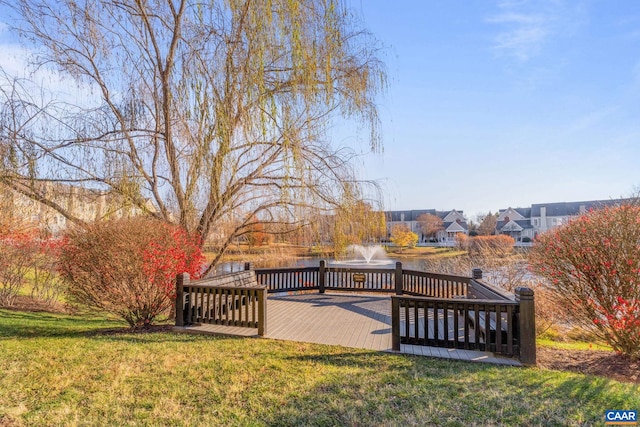 wooden terrace with a lawn