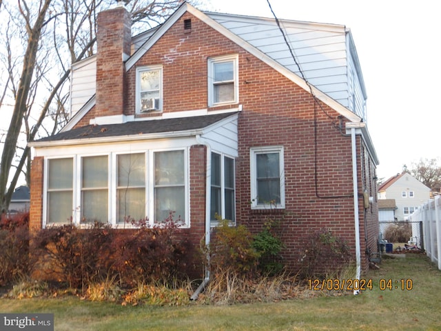 view of side of property with a sunroom