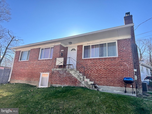 view of front of house featuring a front yard and brick siding