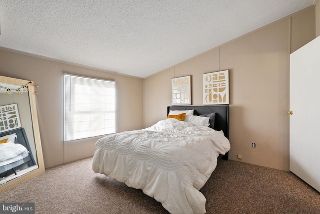 carpeted bedroom featuring a textured ceiling and vaulted ceiling