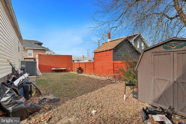 view of yard with a storage shed and central AC