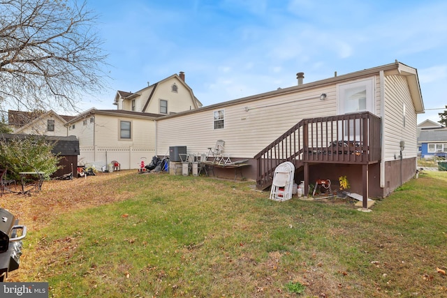 back of house with a lawn and central air condition unit