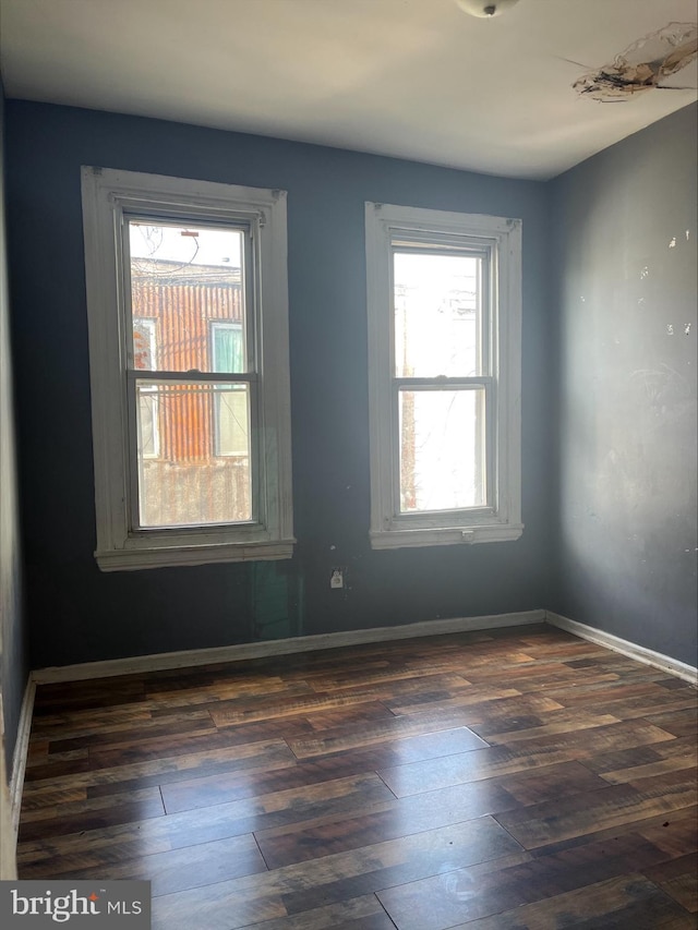 spare room with dark hardwood / wood-style flooring