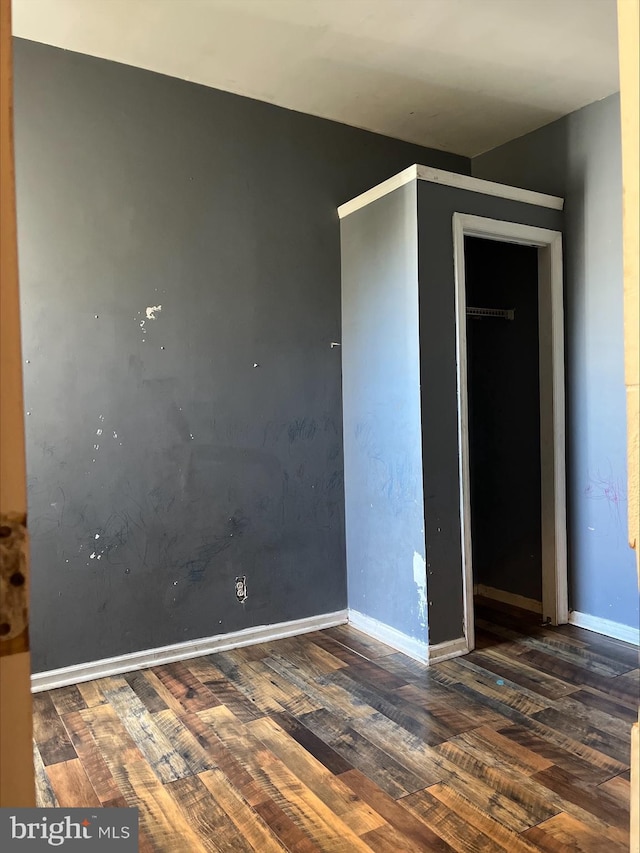 empty room with dark hardwood / wood-style floors