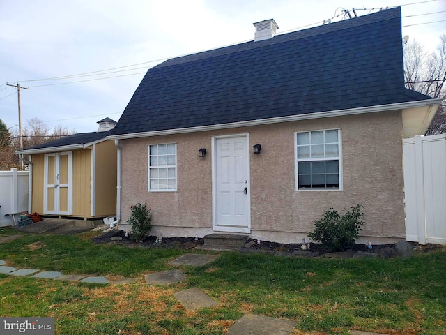 451 Ridge Pike, Lafayette Hill, PA 19444 - view of front of house with entry steps, roof with shingles, a chimney, and stucco siding