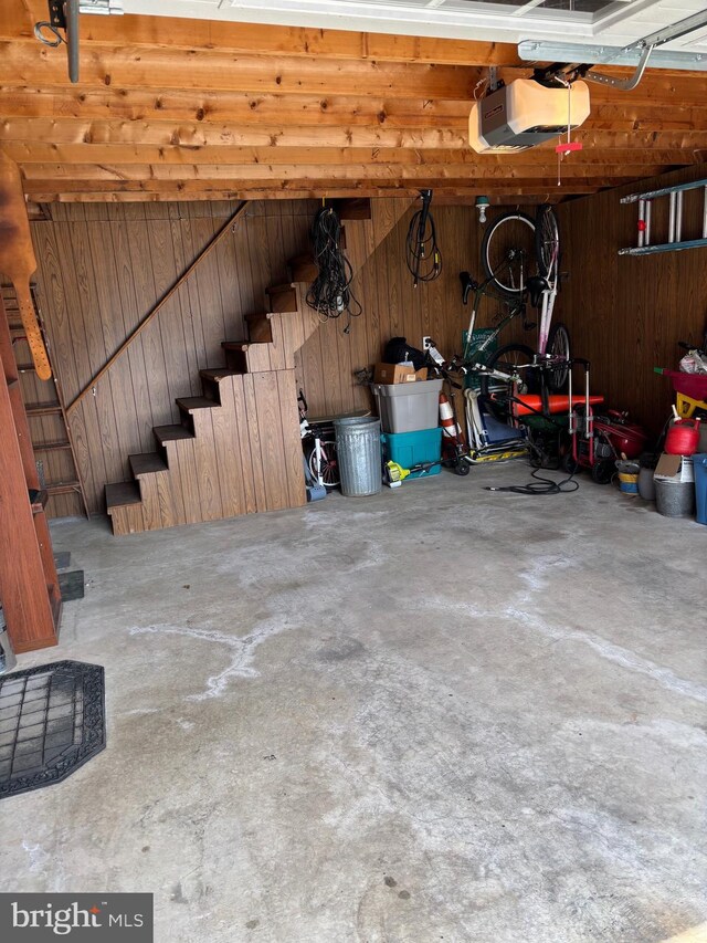 451 Ridge Pike, Lafayette Hill, PA 19444 - garage featuring a garage door opener and wood walls