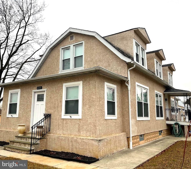 451 Ridge Pike, Lafayette Hill, PA 19444 - back of property with entry steps, stucco siding, and crawl space