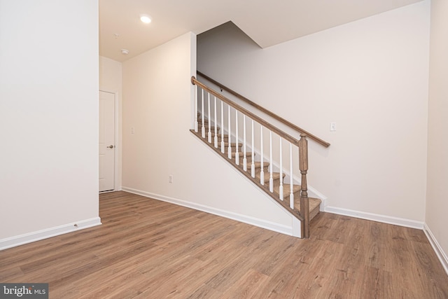 stairway with wood-type flooring