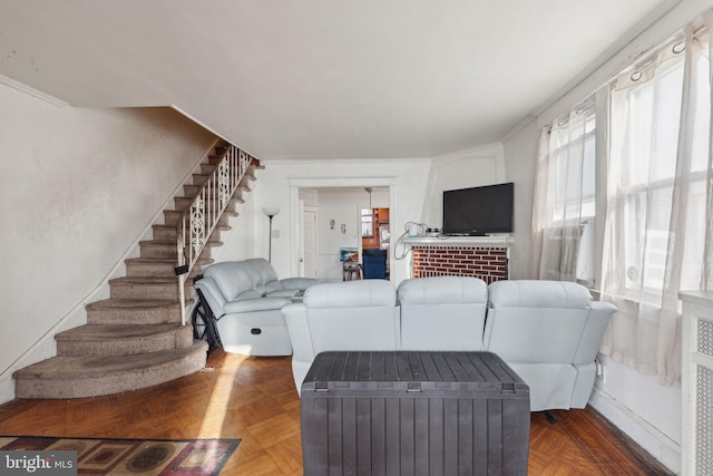 living room featuring parquet floors, plenty of natural light, and crown molding