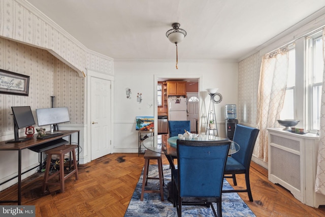 dining area featuring radiator, crown molding, and dark parquet floors