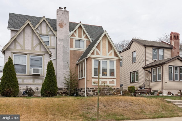 tudor house featuring a front lawn