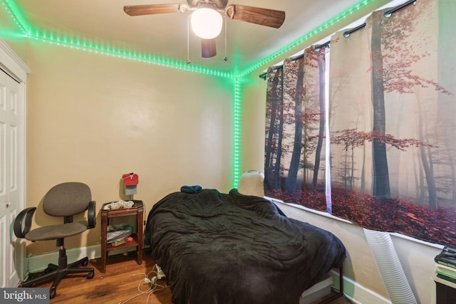 bedroom with ceiling fan and hardwood / wood-style floors