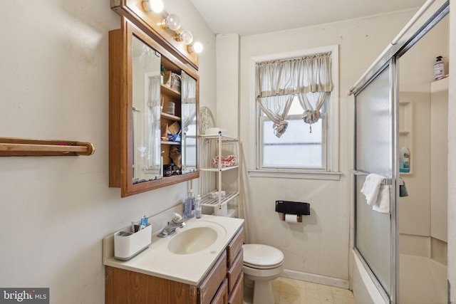 full bathroom with toilet, vanity, and combined bath / shower with glass door