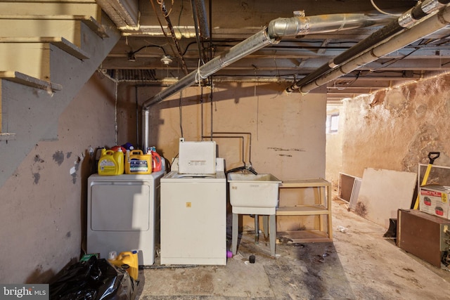 basement with independent washer and dryer and sink