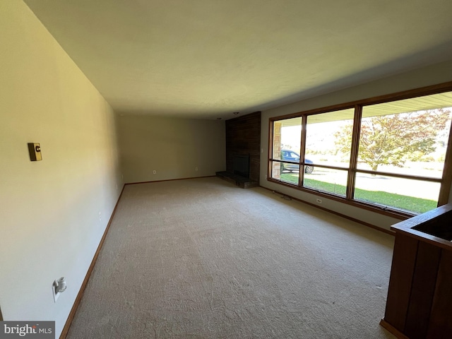 interior space with carpet flooring and a brick fireplace