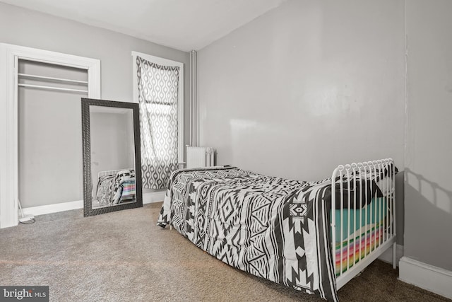 bedroom with radiator heating unit and carpet