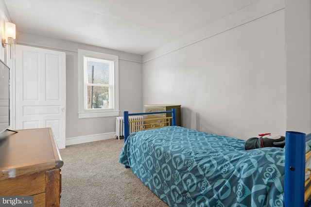 bedroom featuring carpet and radiator heating unit