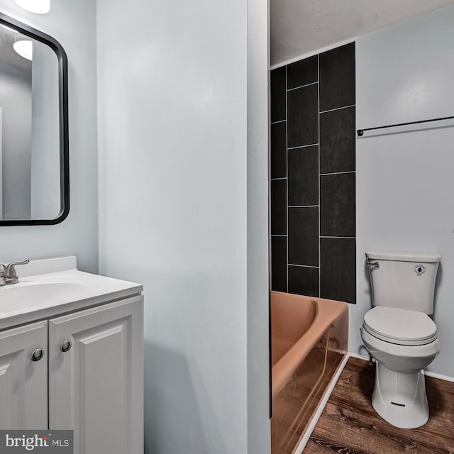 full bathroom featuring vanity, toilet, wood-type flooring, and tiled shower / bath