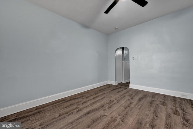 empty room with ceiling fan and dark wood-type flooring