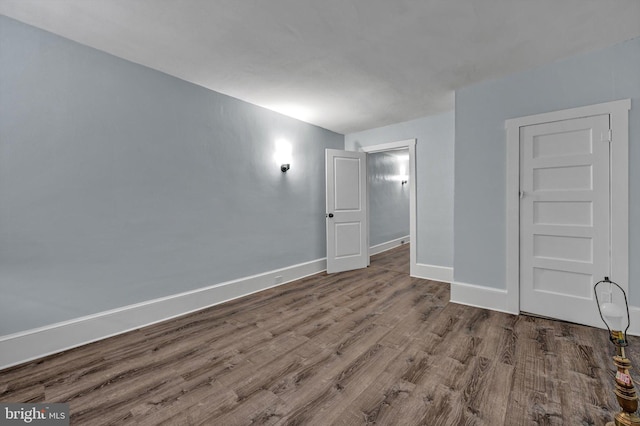 spare room featuring wood-type flooring