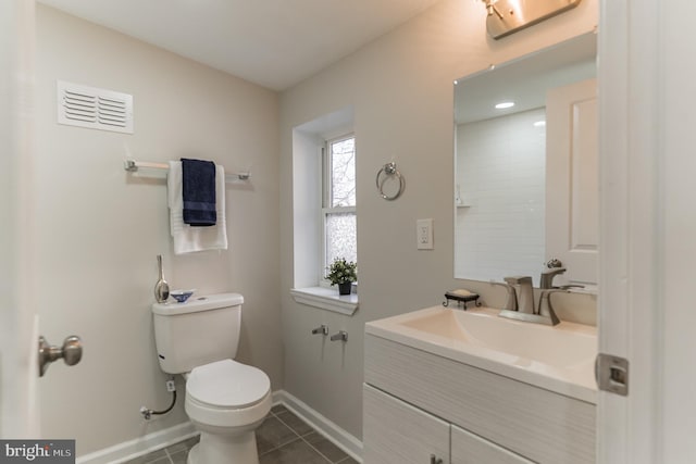 bathroom featuring tile patterned flooring, vanity, and toilet