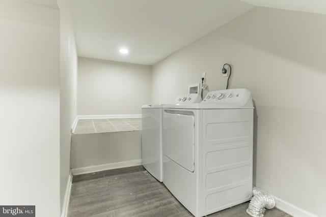 washroom with hardwood / wood-style floors and washer and clothes dryer