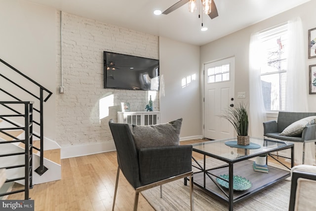 living room featuring hardwood / wood-style flooring and ceiling fan