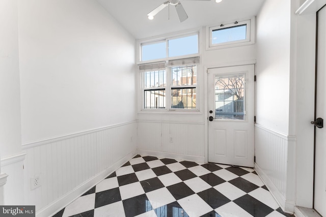 doorway with ceiling fan and a healthy amount of sunlight